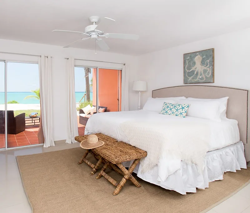 A one-bedroom oceanview room at Bimini Cove Resort & Marina with sliding doors opening to a beachfront patio