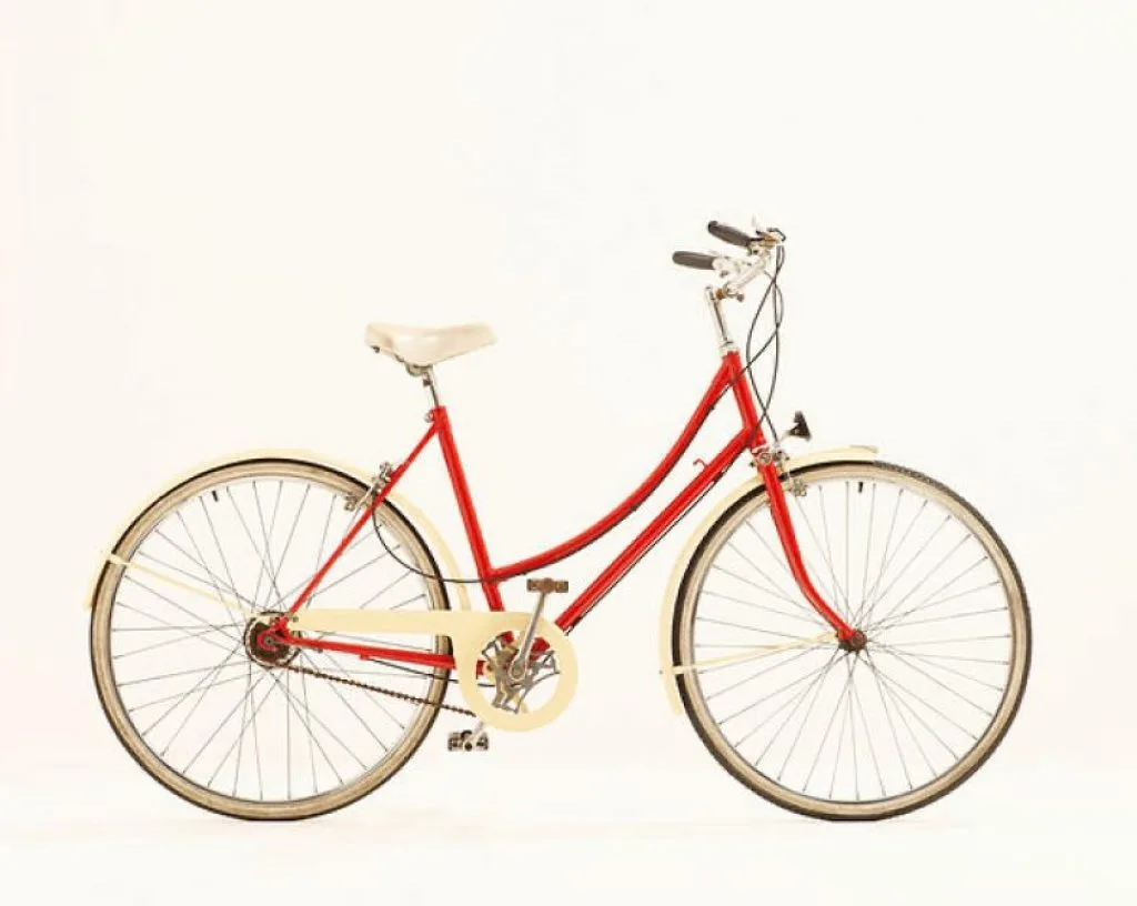 A red cruiser-style rental bicycle with a cream saddle and fenders, shown against a plain background